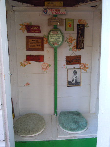 Outhouse interior with two toilet seats