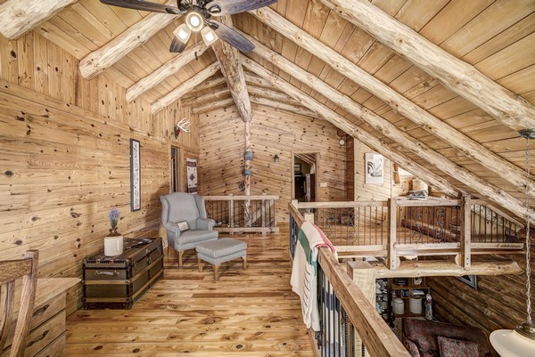 Wood paneling and log cabin upstairs balcony