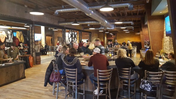 Round Man Brewing Co inside with long bar filled with people