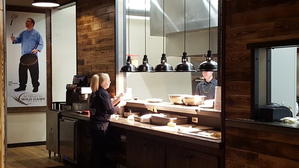 Brewery kitchen staff talking by the orders