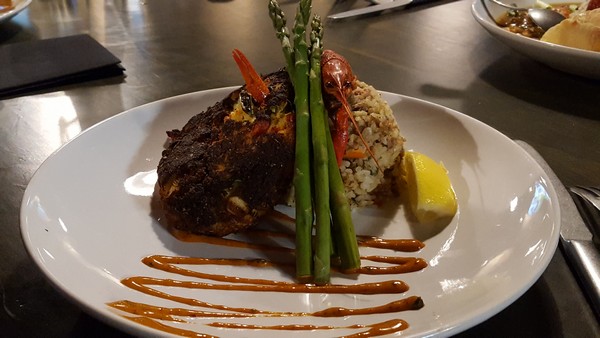 Crabcake with asparagus and lemon as a special Mardi Gras item