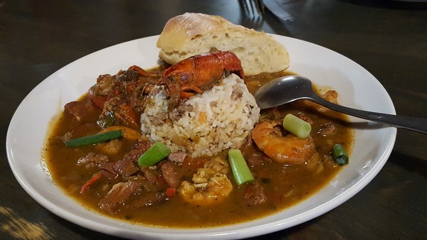 Shrimp Etouffee with rice and bread as a Marti Gras item