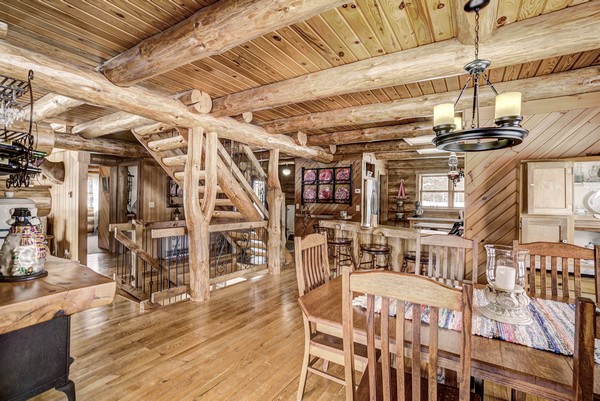 Wood paneling cabin interior with giant log beams