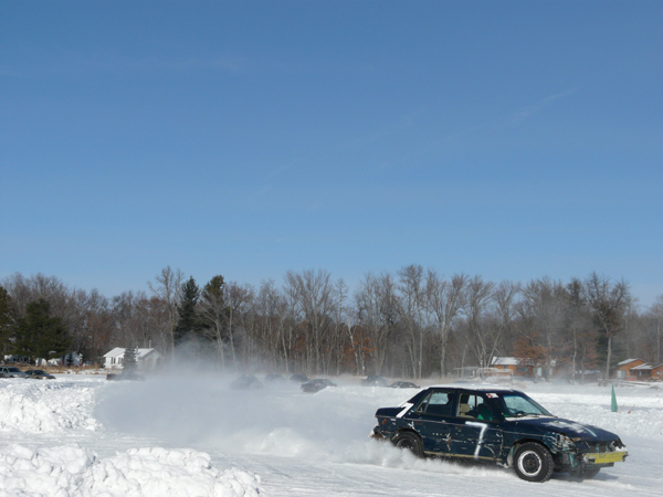 Helene's Dodge Shadow racing around kicking up snow