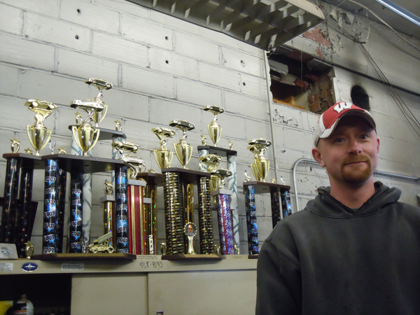 Mark Helene Mark Helene standing next to many tall trophies