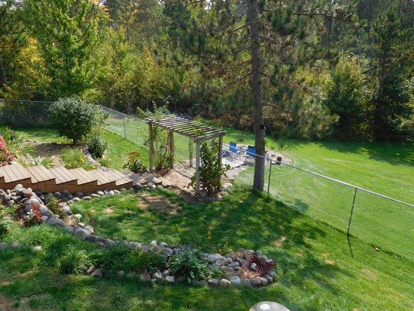 Attractive, low maintenance landscaping and a fire pit waiting for your coals.