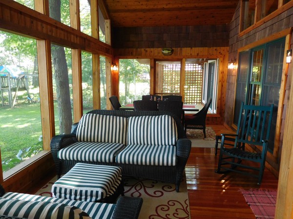 Screened in porch with tall windows and dining areas