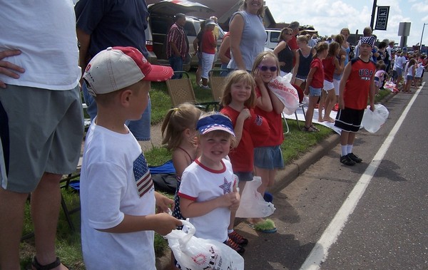 Children smiling during Fourth of July parade