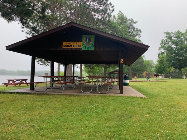 Pavilion in Siren with park benches near the water