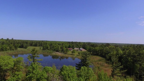 Aerial view of large C21 property with small body of water