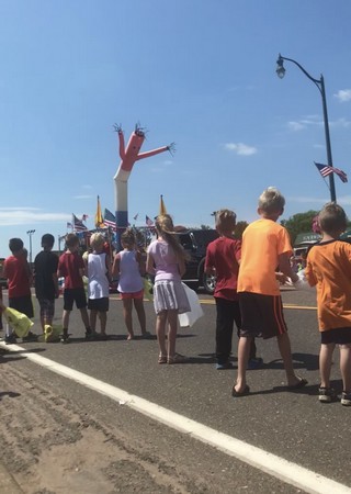 Red white and blue inflatable tube man in parade