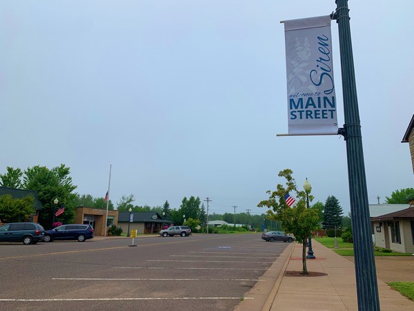 Siren Main Street sign on lightpost near parking lot