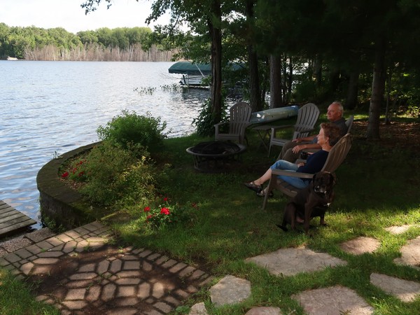 John and Evalee Miller sitting outside looking at the lake