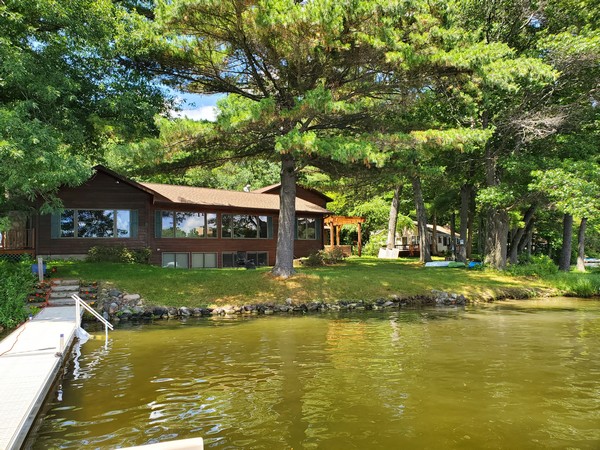 Large cabin property with large windows on lake