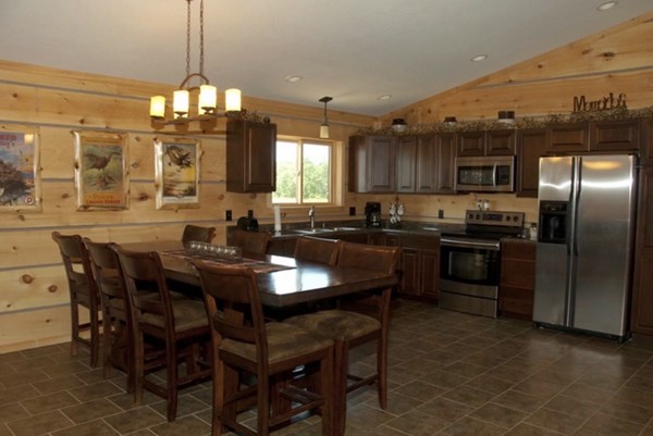 Bunkhouse kitchen with dark wood cabinets and chairs