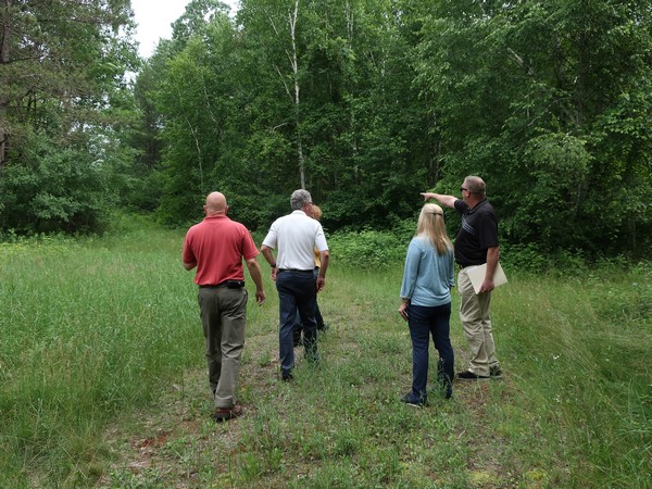 Century 21 agents surveying the land of a property