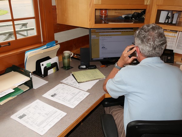 Century 21 real estate agent in the office on the phone