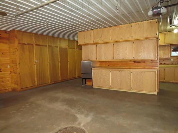 Interior of Webster, WI garage with wood shelves and walls