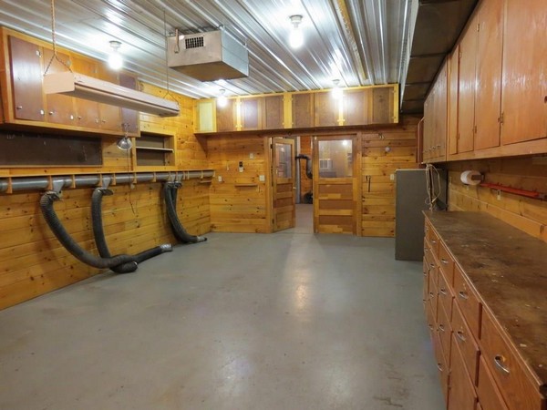 Room in Webster garage with wood cupboards and walls