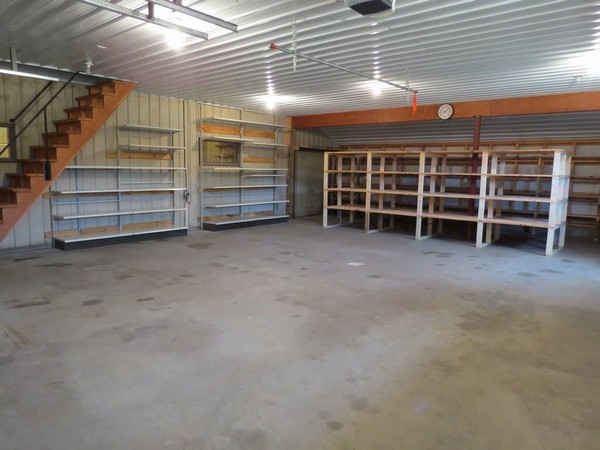 C21 Webster WI property with shelving units and cement floor