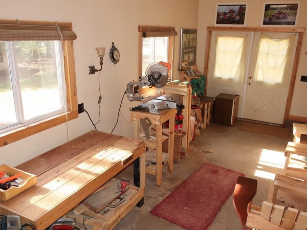 Interior of wood working shop with bench and saw