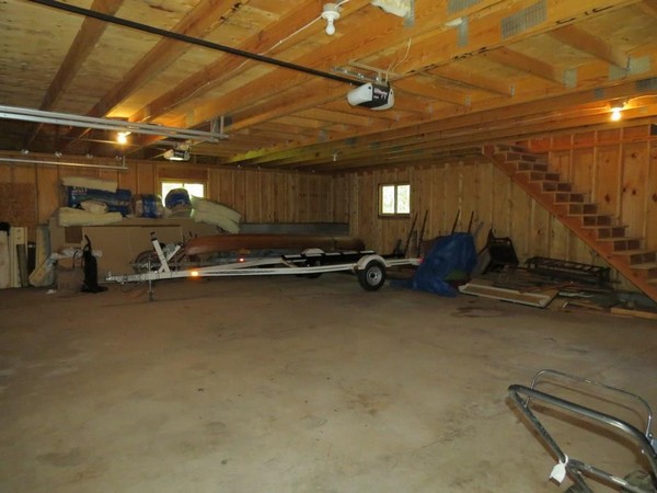 Interior of garage with wood walls and cement floor