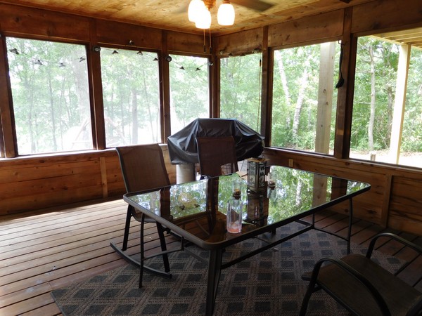 Screened porch with dim lighting and few seating