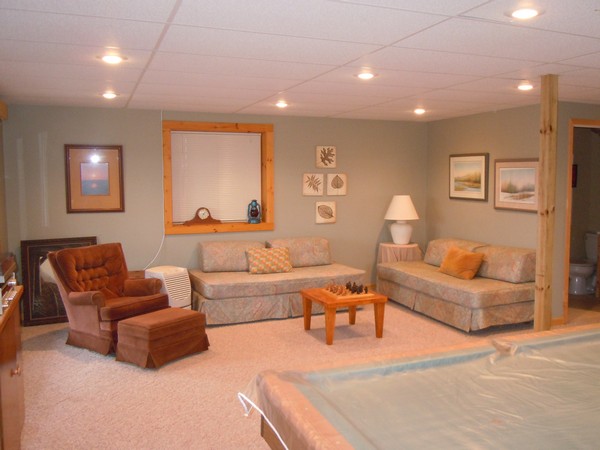 Well lit basement with furniture