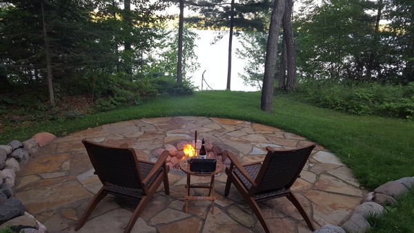 Small fire pit surrounded by flat stones and seating area