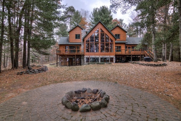 Paths to the lake and the swing radiate from the fire pit with paver stone